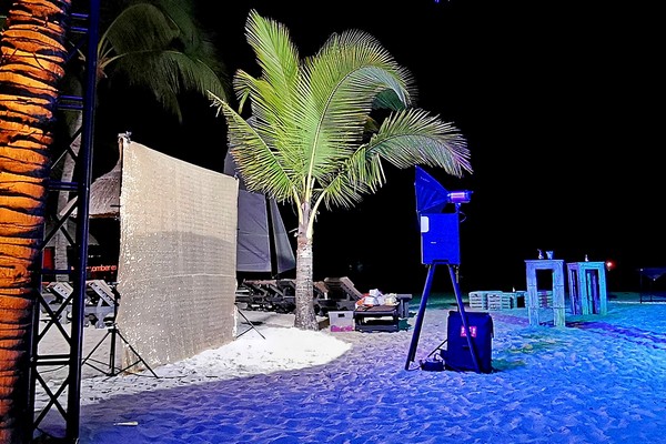 Photo booth setup on the beach in the north of Mauritius at night with golden backdrop