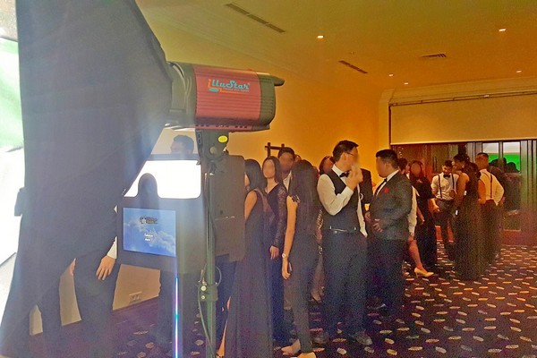 Guests queuing and waiting to take photo with photo booth at Hilton Hotel for End of year event
